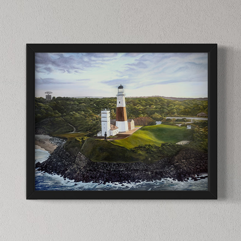 Framed painting of a lighthouse on a rocky outcrop with a coastal landscape.
