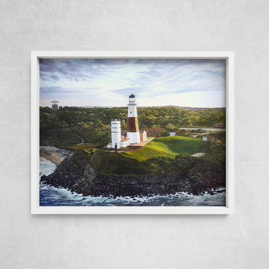A framed art print depicting Montauk Lighthouse with a coastal landscape, captured from an aerial perspective.