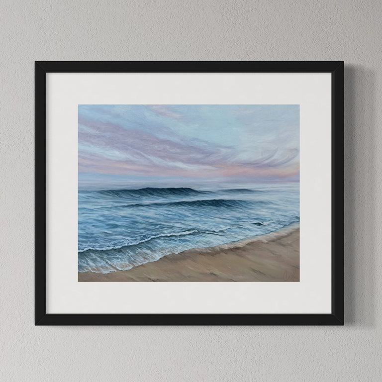 Framed artwork of a beach scene with waves and sky.