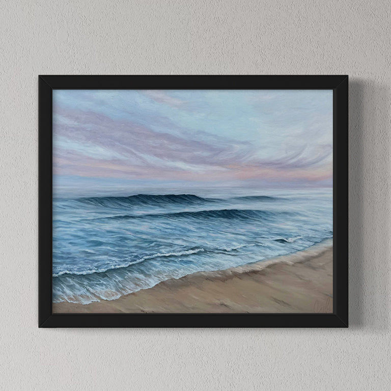 Framed artwork of a beach scene with waves and a sky.