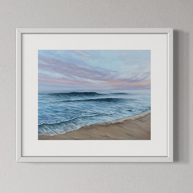 Framed artwork of a beach scene with waves and sky.