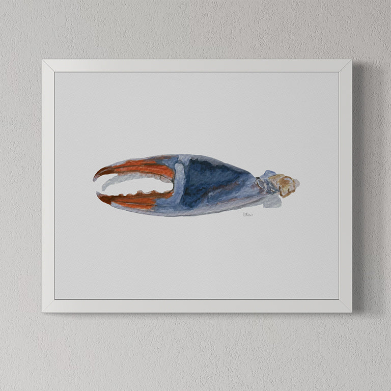 Framed artwork of a blue and orange crab claw on a gray wall