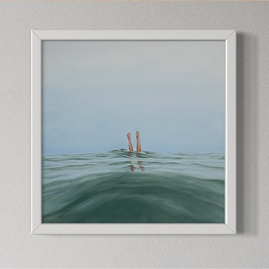 Framed artwork of legs emerging from water on a gray wall