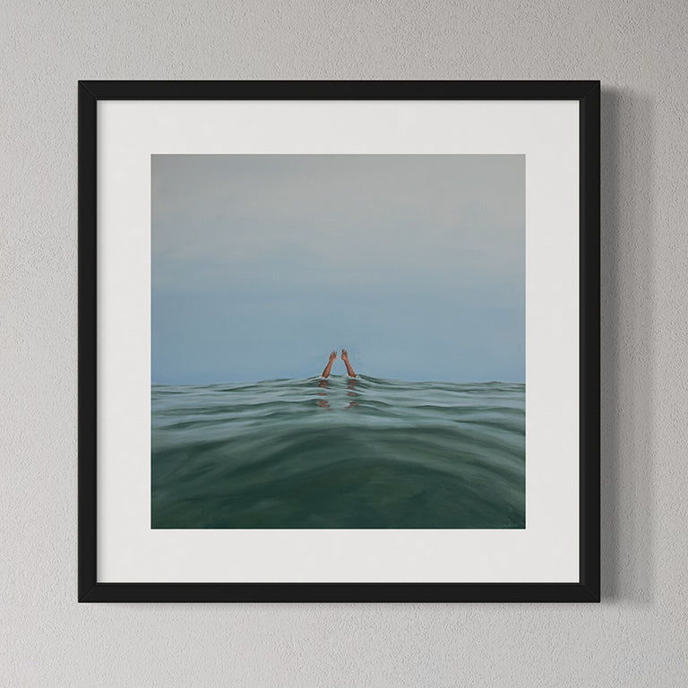 Framed artwork of two hands emerging from water on a gray wall
