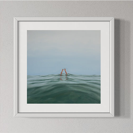 Framed artwork of a person partially submerged in water with a minimalistic background