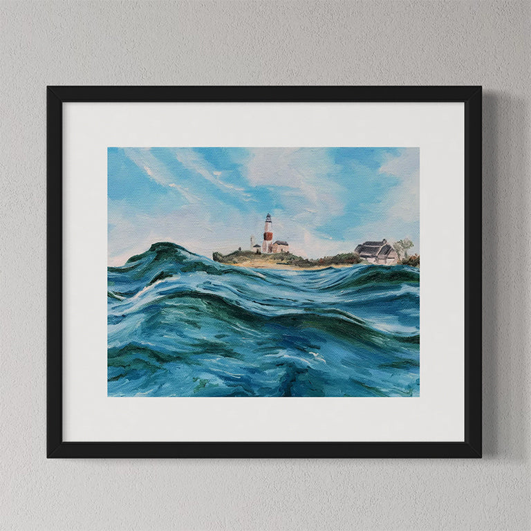 Framed painting of a lighthouse by the sea on a gray wall