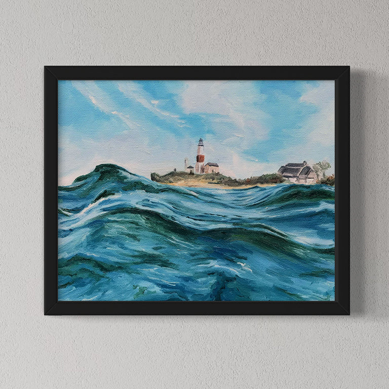 Framed painting of a lighthouse with crashing waves on a gray wall