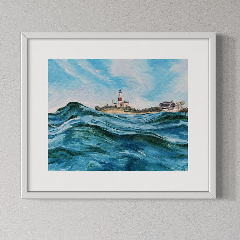 Framed painting of a lighthouse by the sea on a gray wall