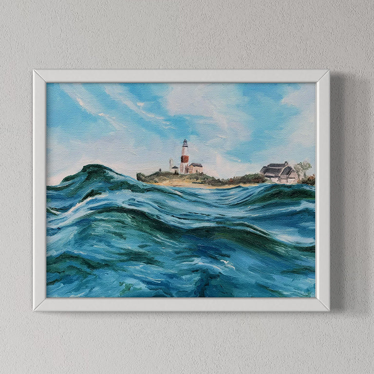 Framed painting of a lighthouse by the sea on a gray wall