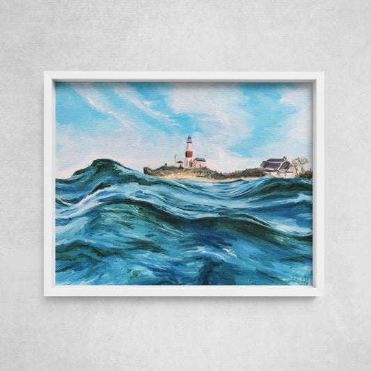 A framed fine art paper print depicting a vibrant ocean scene with rolling waves and a lighthouse in the background.