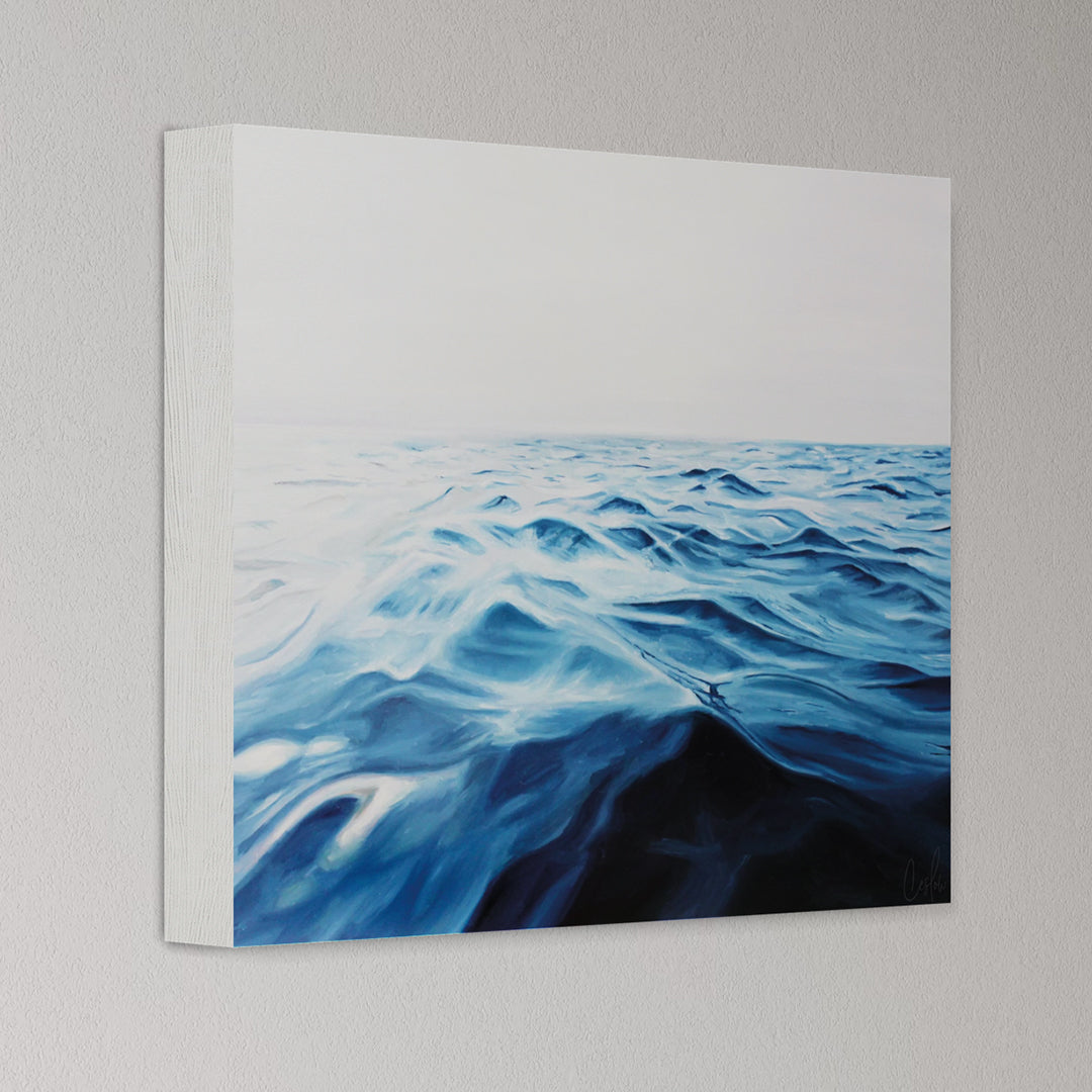 Canvas print of a blue ocean wave on a gray wall