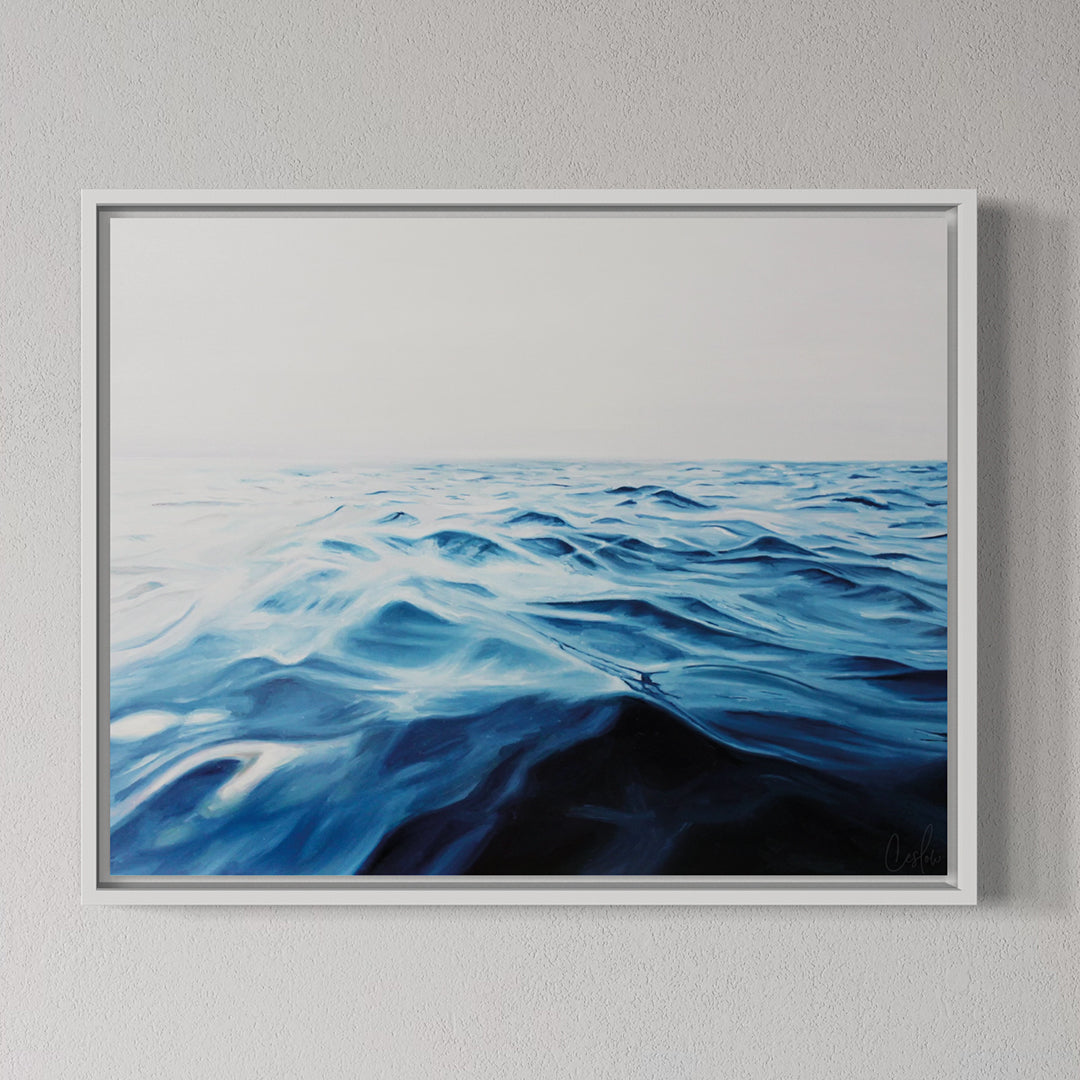 Framed artwork of wavy blue and black pattern on a gray wall