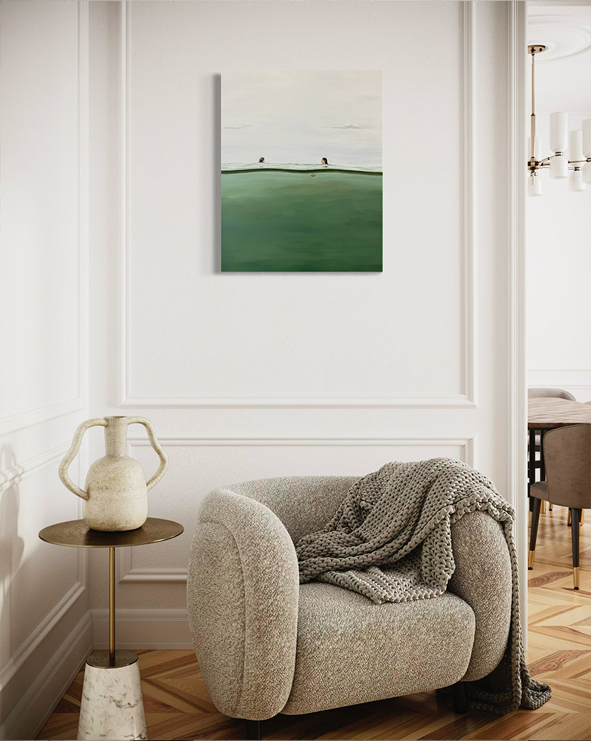 Cozy living room with a textured armchair, side table, and wall art.