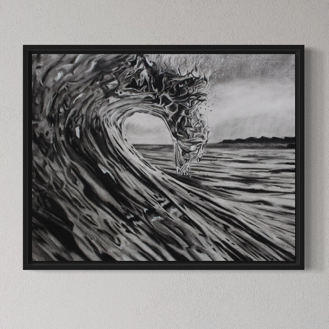 Framed artwork of a black and white wave on a gray wall