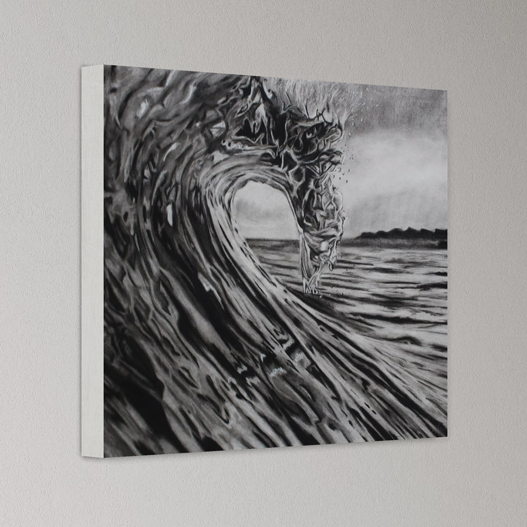Canvas print of a black and white wave design on a plain wall.