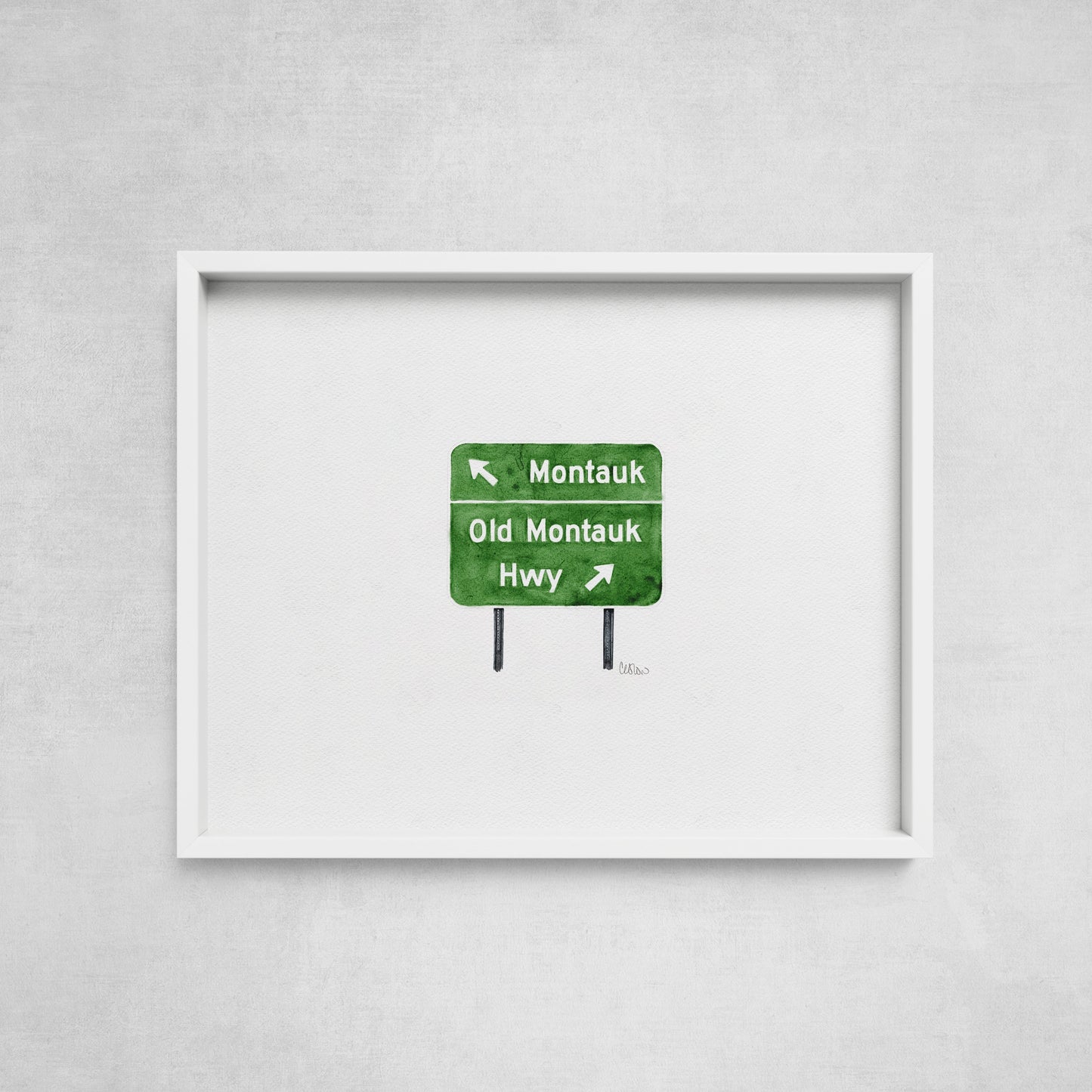 Framed artwork of a green road sign on a gray wall