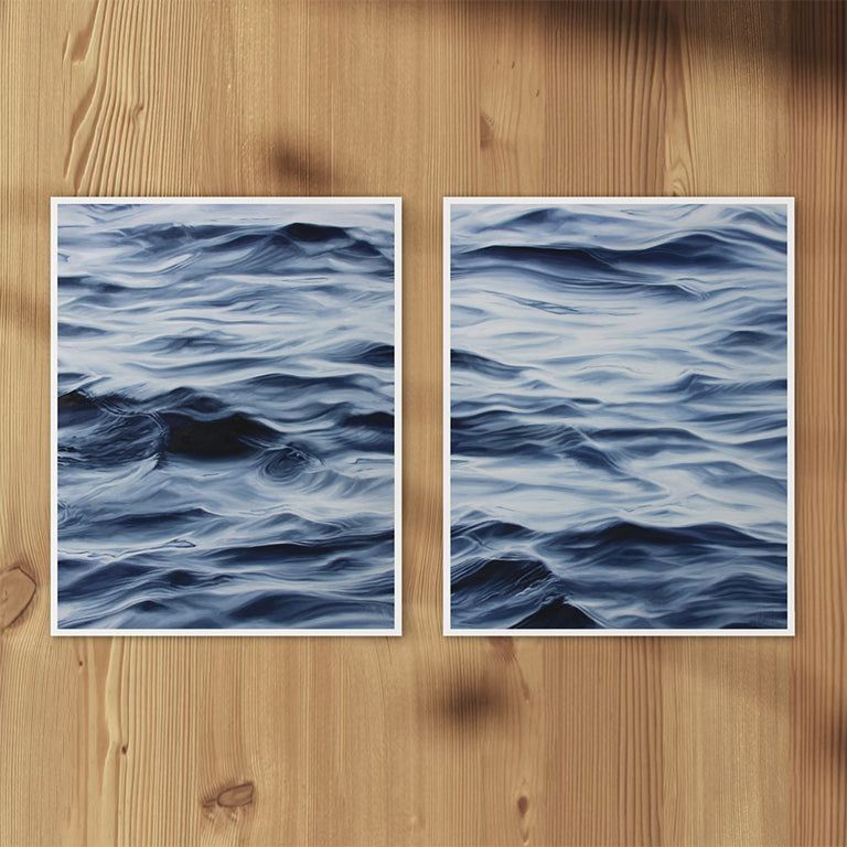 Two blue wave-patterned posters on a wooden surface