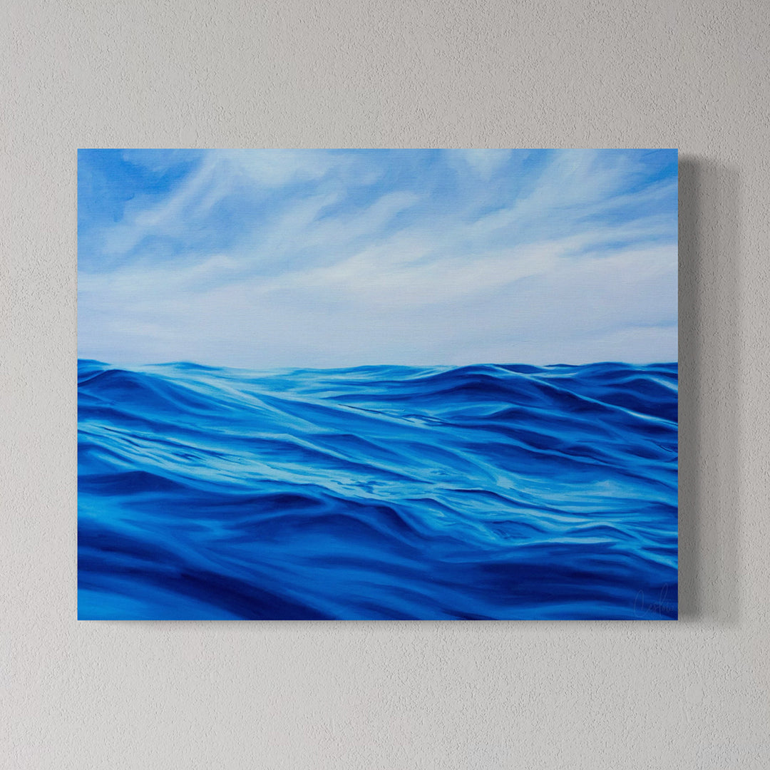 Canvas print of blue ocean waves and sky on a gray wall