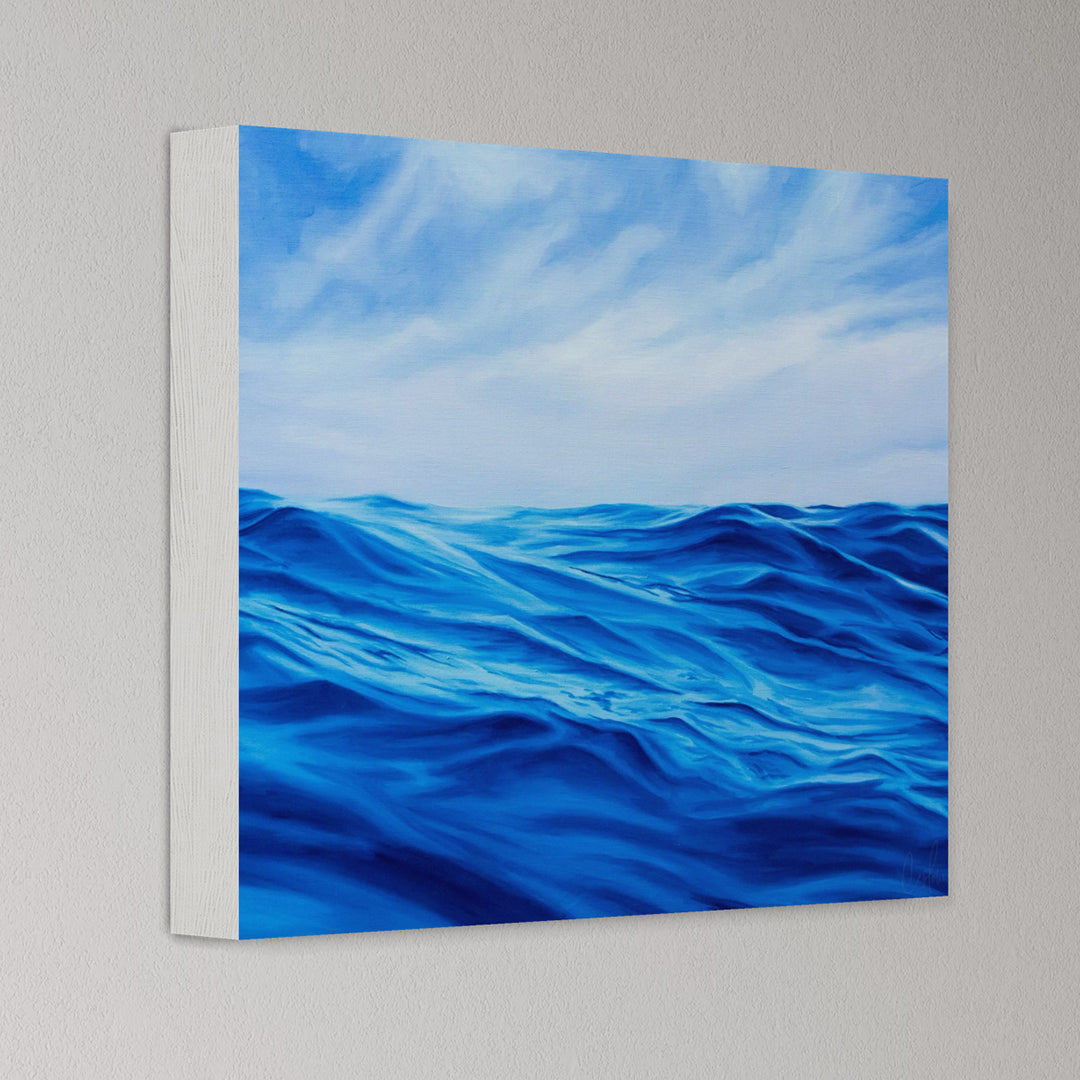 Canvas print of blue ocean waves and sky on a gray wall