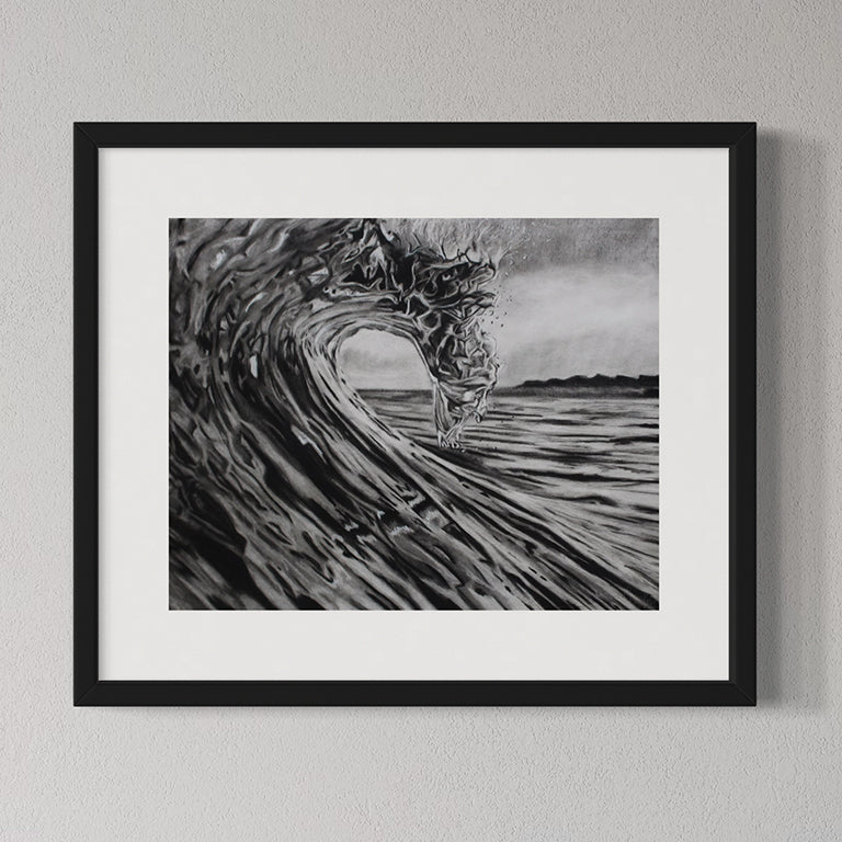 Framed black and white artwork of a wave on a gray wall
