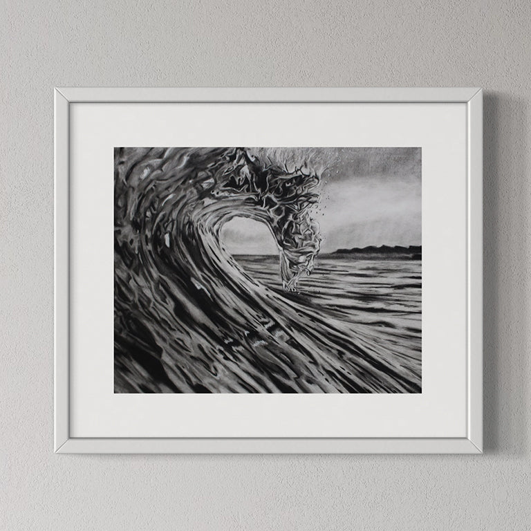 Framed black and white artwork of a wave on a gray wall