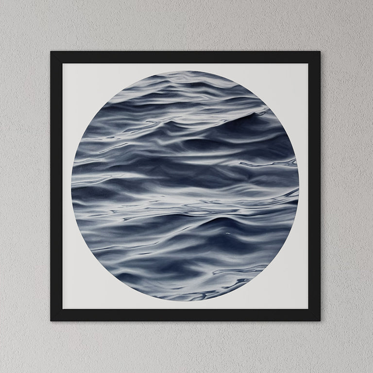 Framed artwork of wavy water pattern on a gray wall