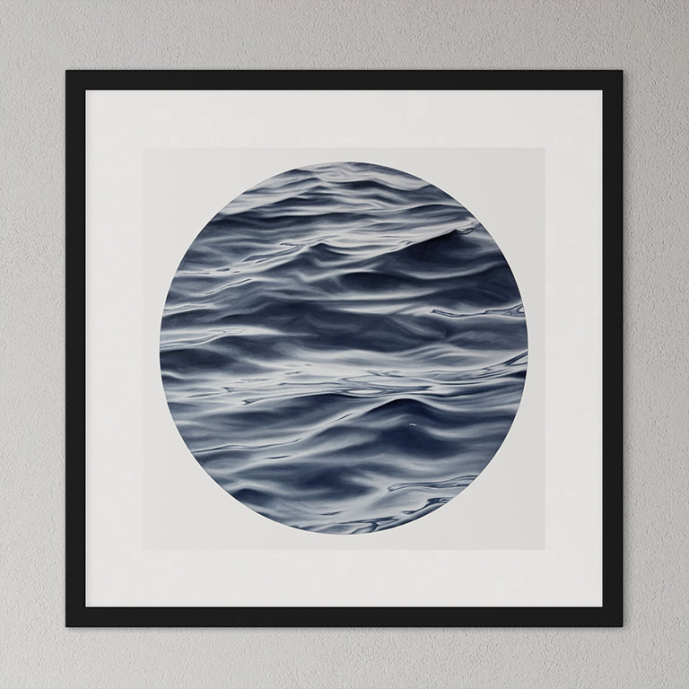 Framed artwork of wavy water pattern on a gray wall