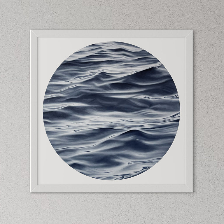 Framed artwork of wavy water pattern on a gray wall