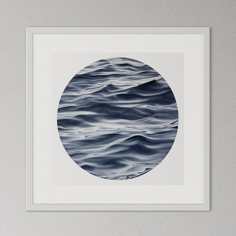 Framed artwork of wavy water pattern on a gray wall
