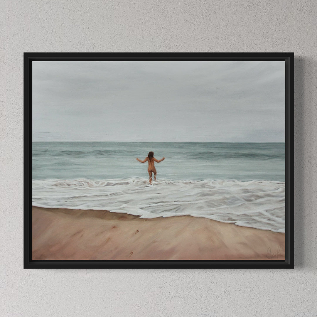 Framed painting of a person walking on a beach with ocean waves.