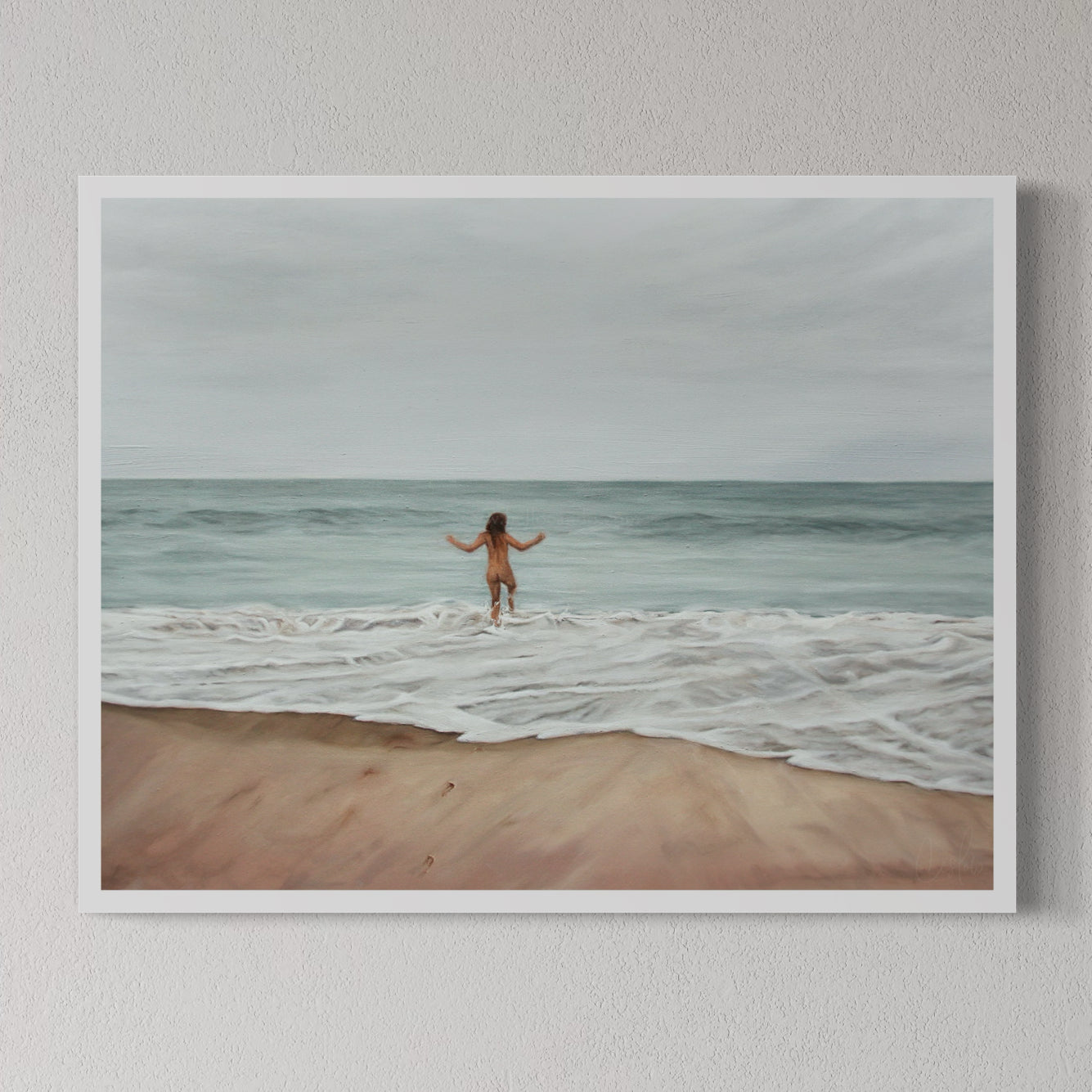 An unframed art print depicting a nude figure standing on a beach with arms raised, facing the ocean.