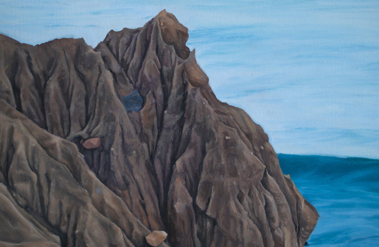 Close-up of a textured brown rock formation against a blue background