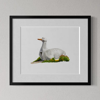 Framed artwork of of The Big Duck landmark in Flanders, Long Island, NY on grass against a gray wall