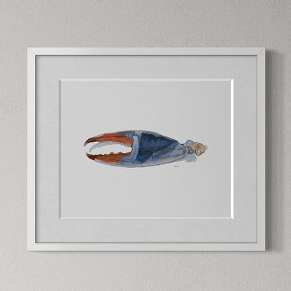 Framed artwork of a crab claw on a gray wall