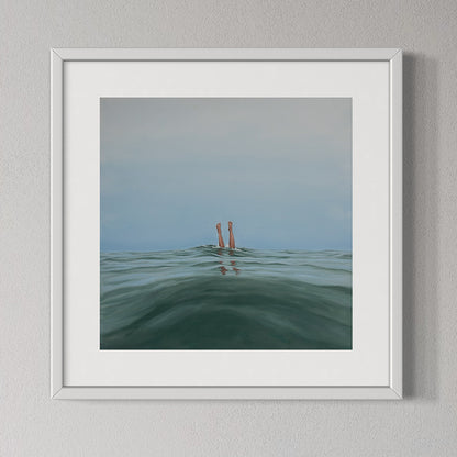 Framed artwork of a person standing in water with a gradient sky.