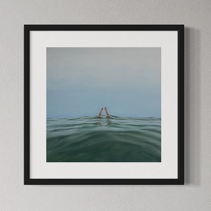 Framed artwork of two hands emerging from water on a gray wall