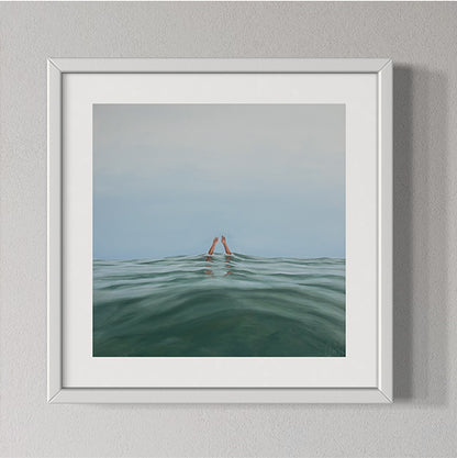 Framed artwork of a person partially submerged in water with a minimalistic background