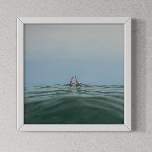 Framed artwork of hands emerging from water against a blue sky.
