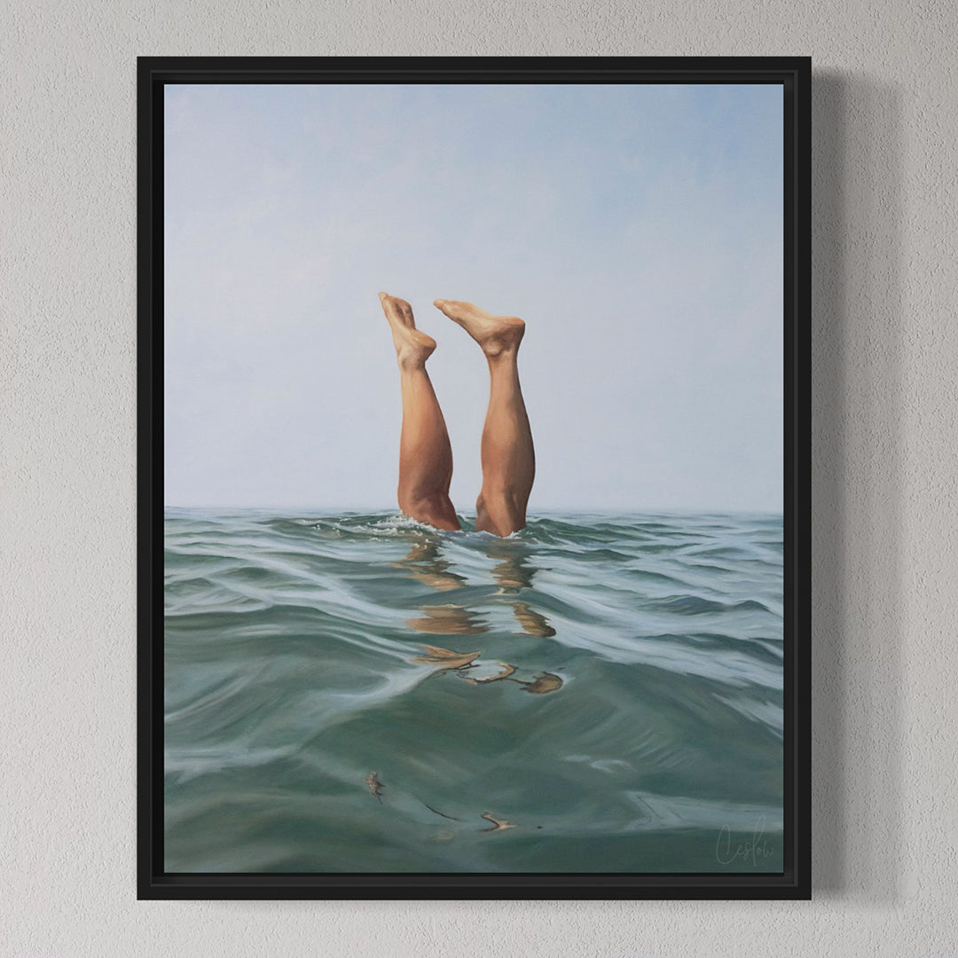 Framed artwork of legs emerging from water on a gray wall