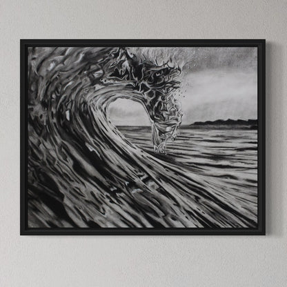Framed artwork of a black and white wave on a gray wall