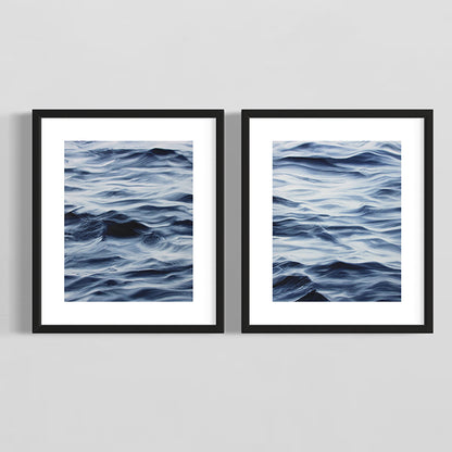 Two framed artworks of wavy blue patterns on a gray background