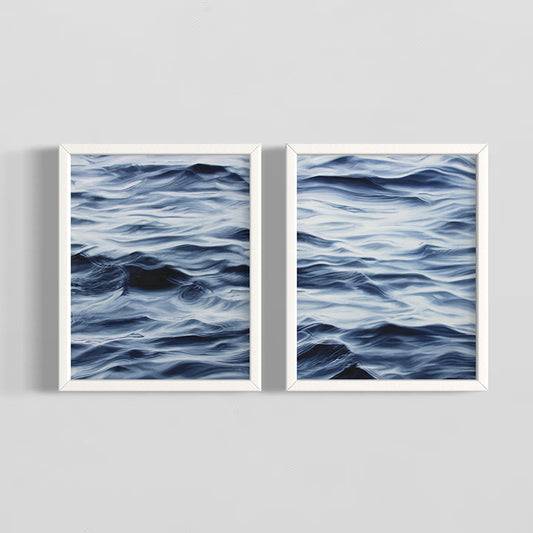 Two framed artworks of wavy blue patterns on a gray background