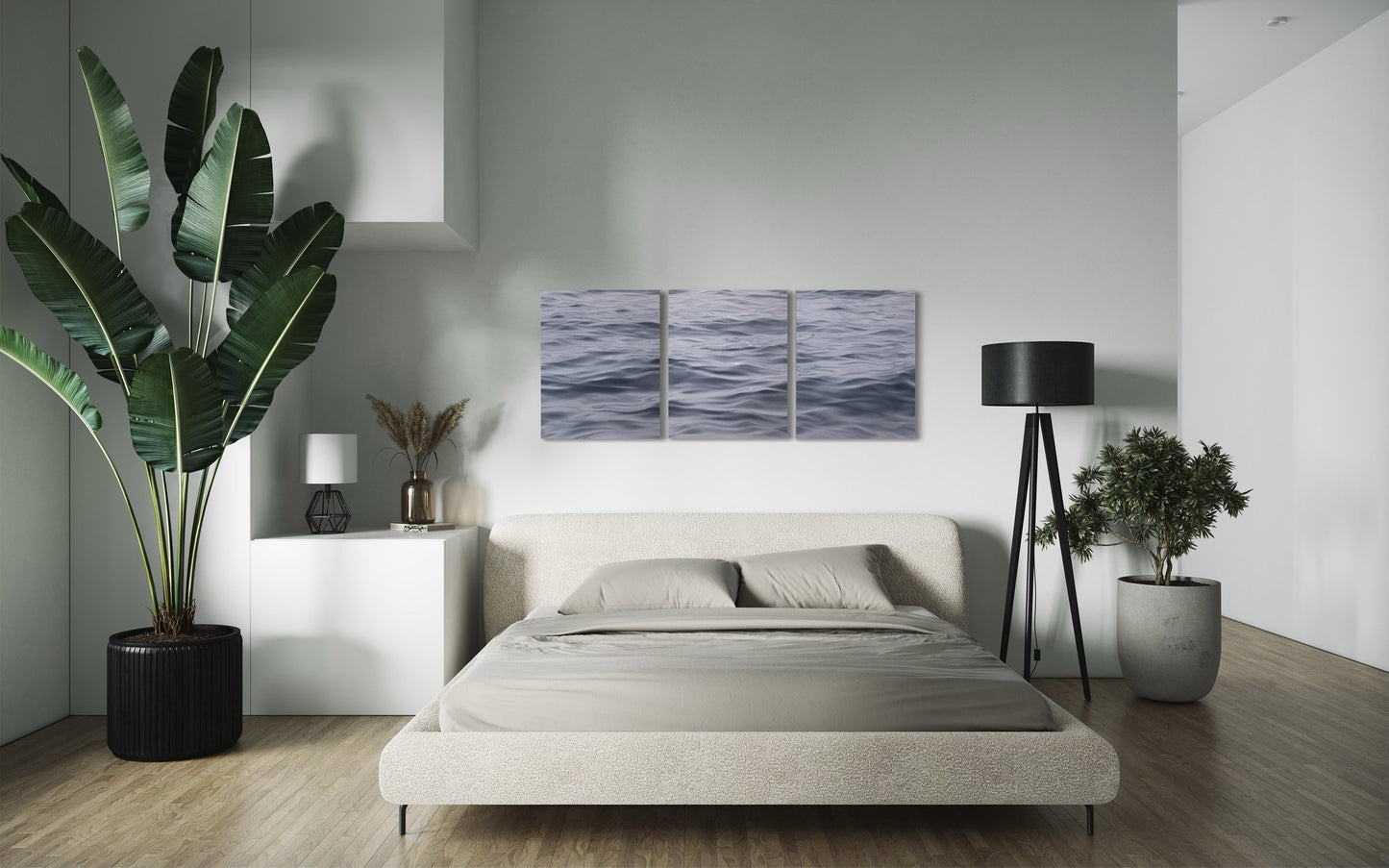 Triptych coastal wall art displayed above bed in minimalist bedroom with greenery and natural light.