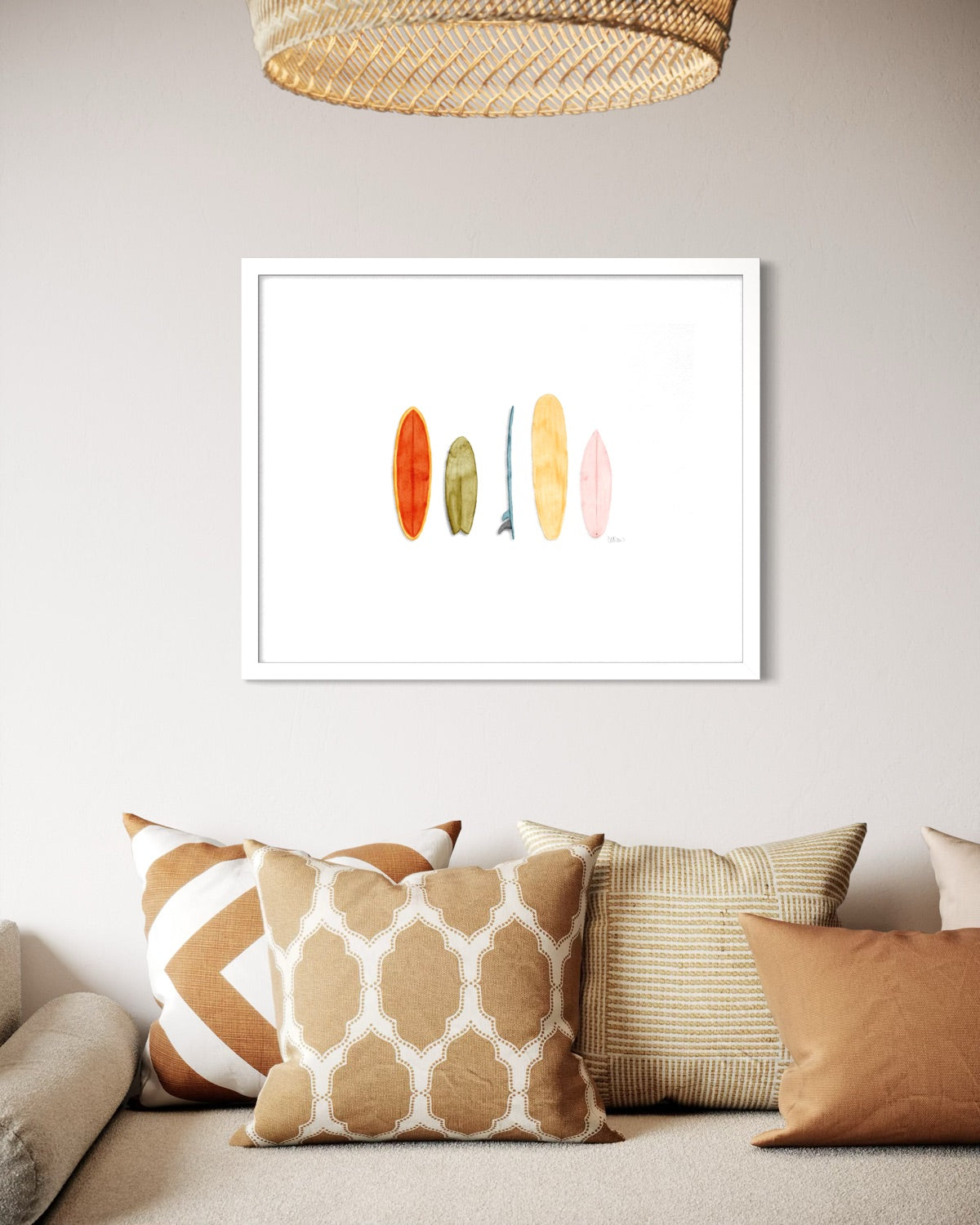 Retro surfboard watercolor print in white frame above coastal boho living room sofa by Candace Ceslow