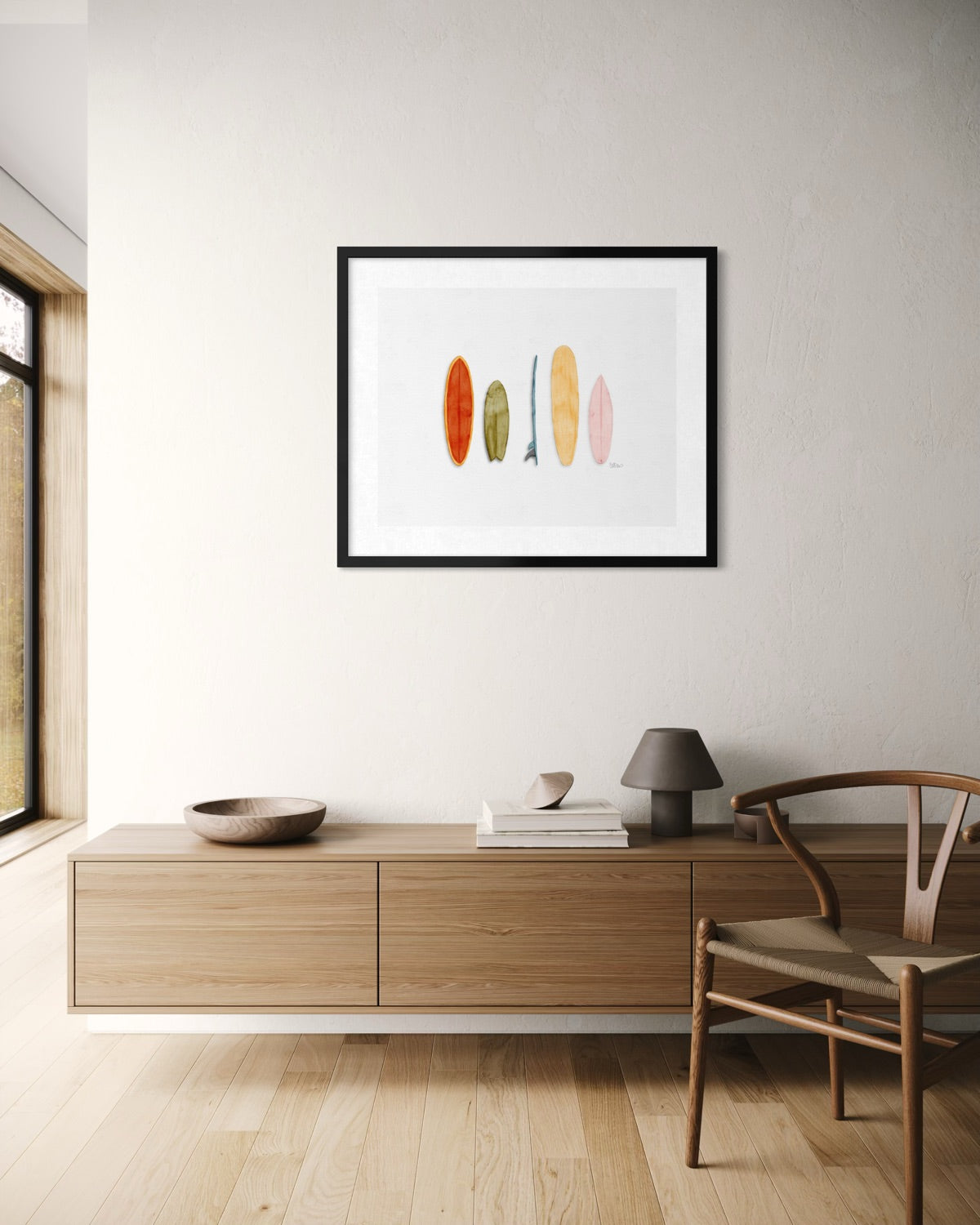 Colorful surfboard watercolor art print in black frame above modern wood credenza by Candace Ceslow