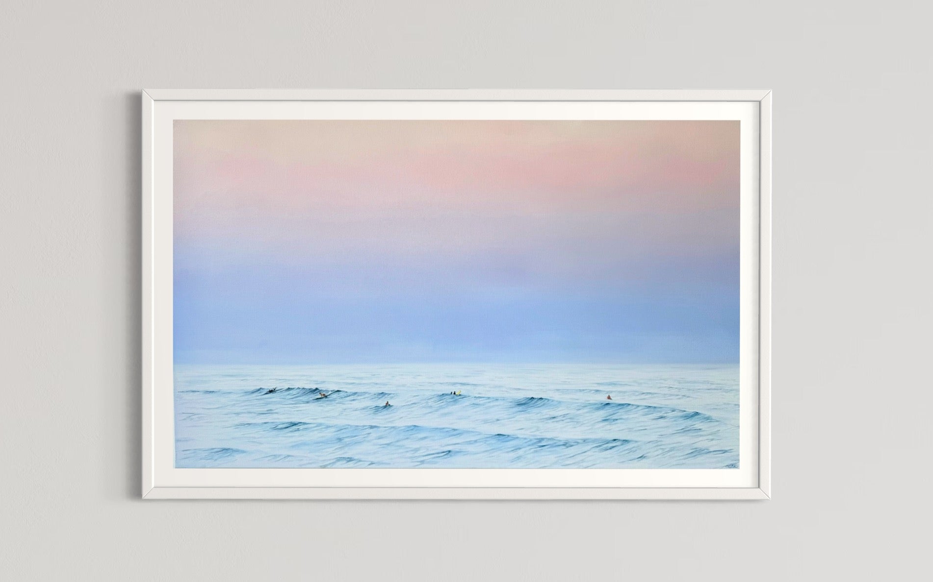 A framed limited edition fine art print titled 'Twilight Whispers' depicting a serene coastal scene with surfers and a pastel-colored sky.