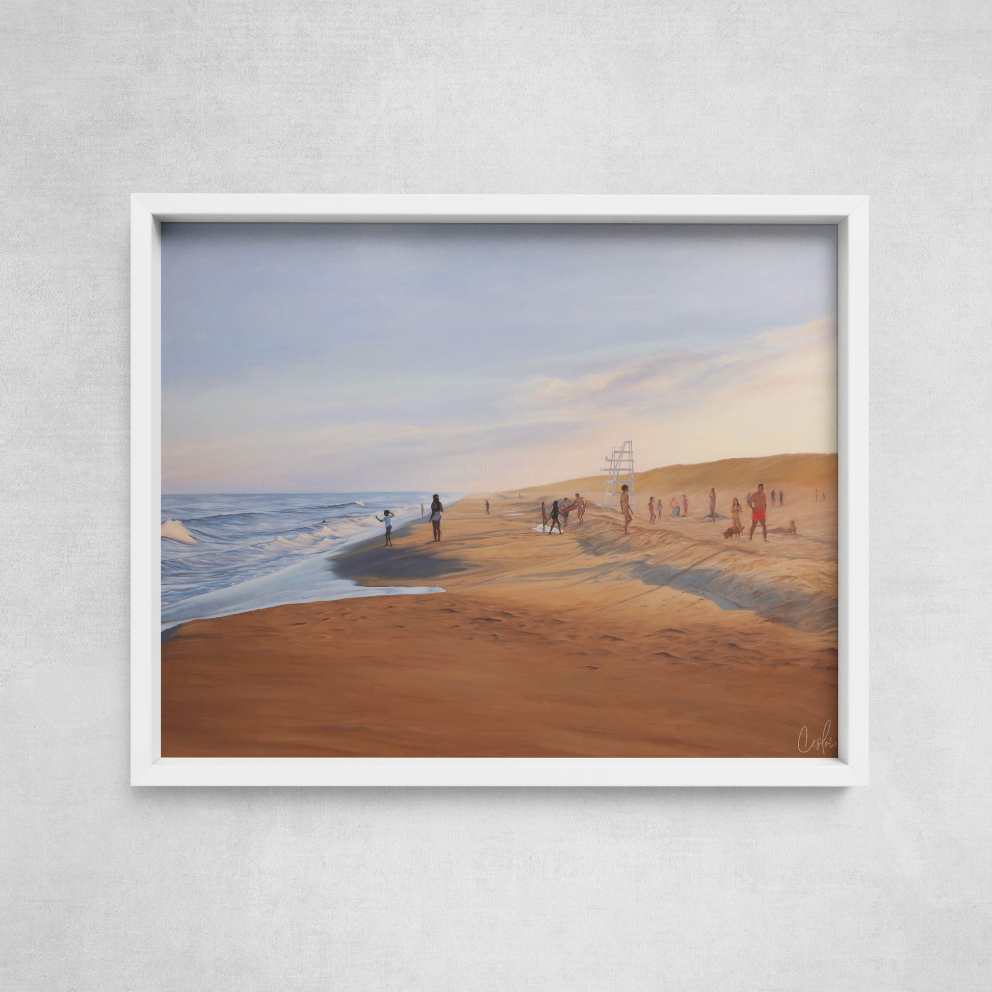 Framed artwork of a beach scene with people on a gray wall.