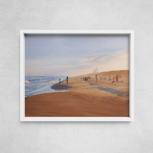 Framed artwork of a beach scene with people on a gray wall.