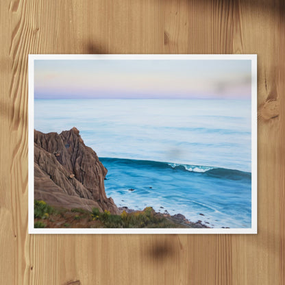 All We Have is Here fine art print of a coastal cliff and wave, laid flat on a wood surface