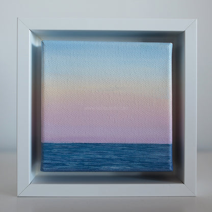 Soft Horizon — Mini #44 pastel coastal oil painting in white frame, blue ocean and pink sky gradient by Montauk artist Candace Ceslow.”